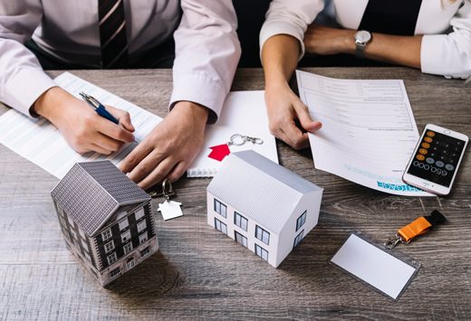 Model buildings and paperwork on a desk