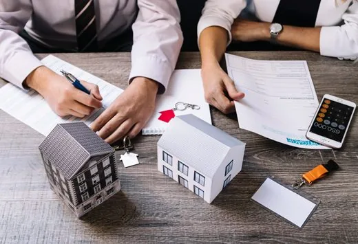 Model buildings and paperwork on a desk