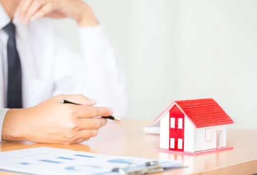 Advisor presenting a model house